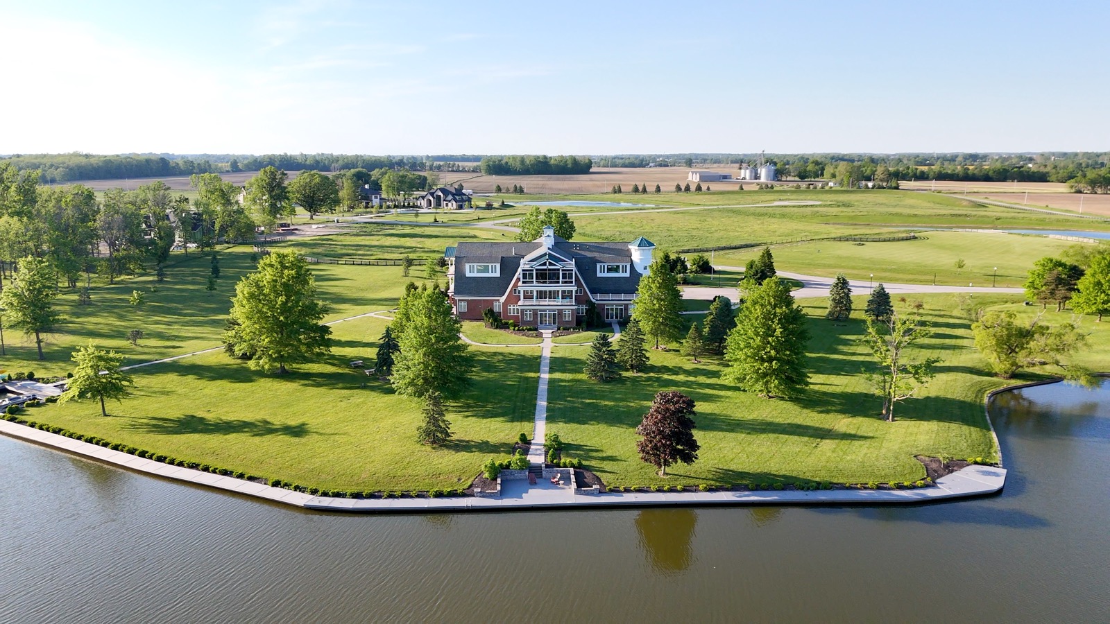 Aerial view across the lake toward the estate at The Agency Indianapolis event