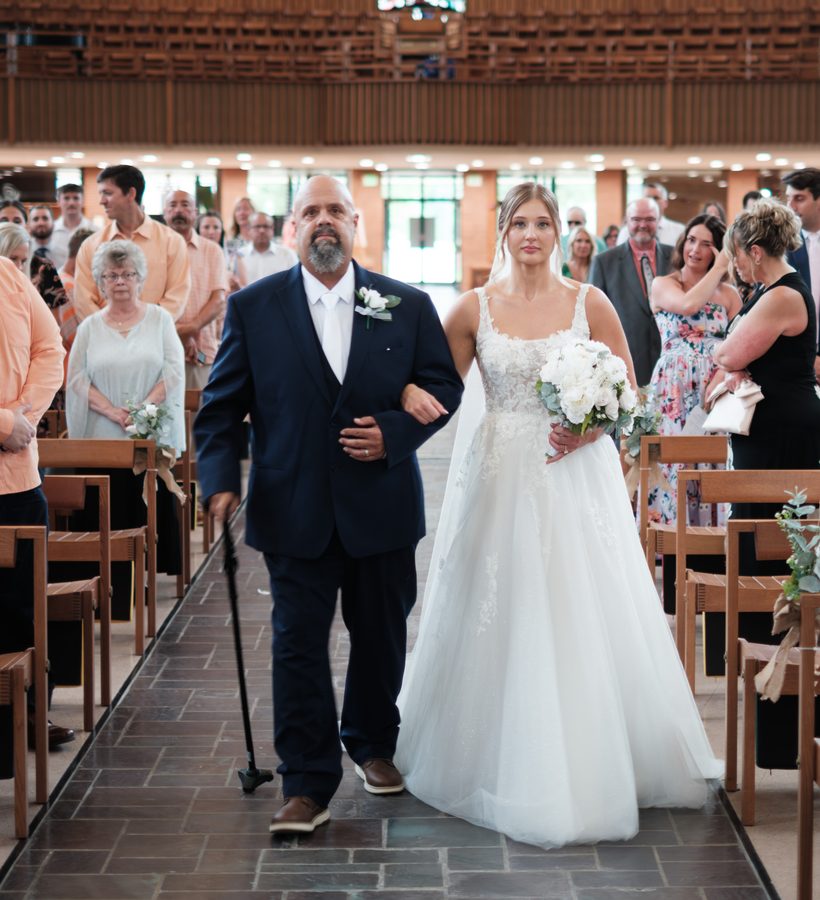 Alyssa and her dad walking down the aisle