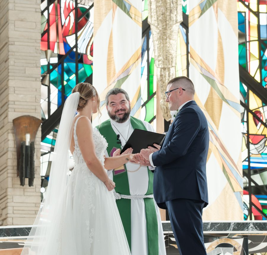 Alyssa and Eric holding hands during their vows