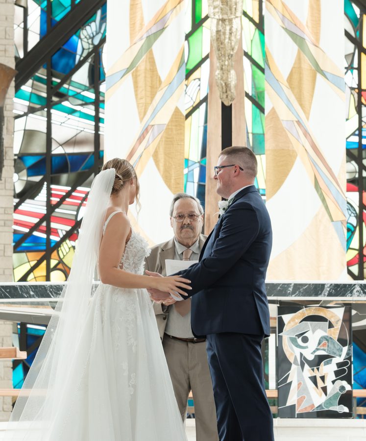 Alyssa and Eric facing each other at the altar