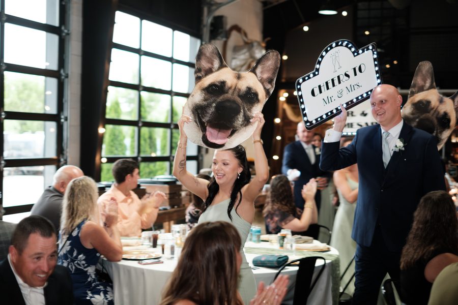 Guests holding up Tito signs at The Design Barn
