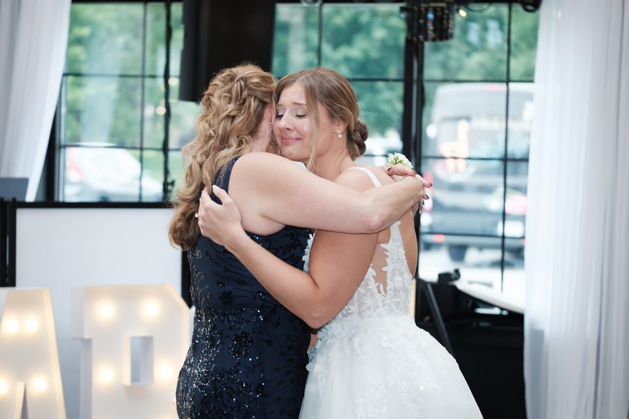 Alyssa and her mom embracing on the dance floor