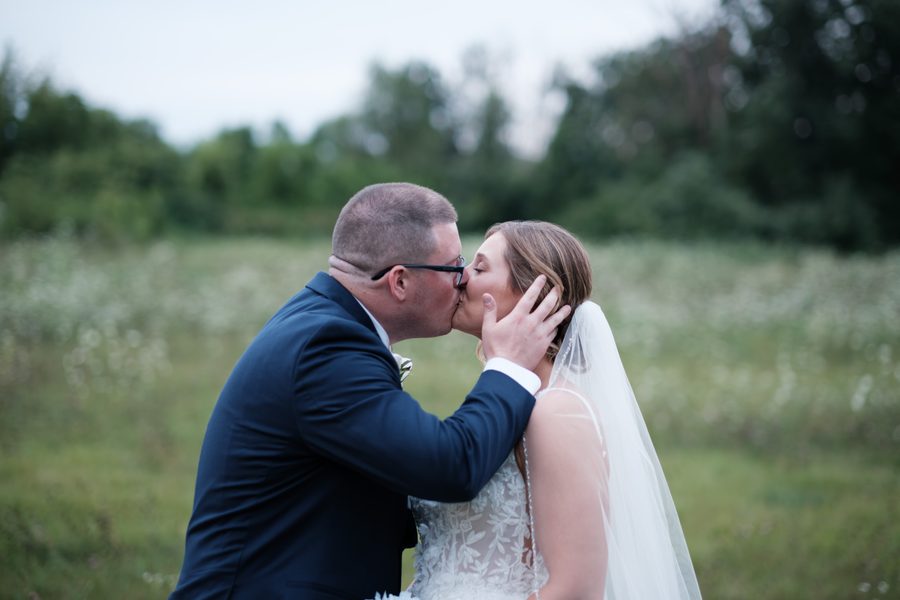 Eric kissing Alyssa in the field