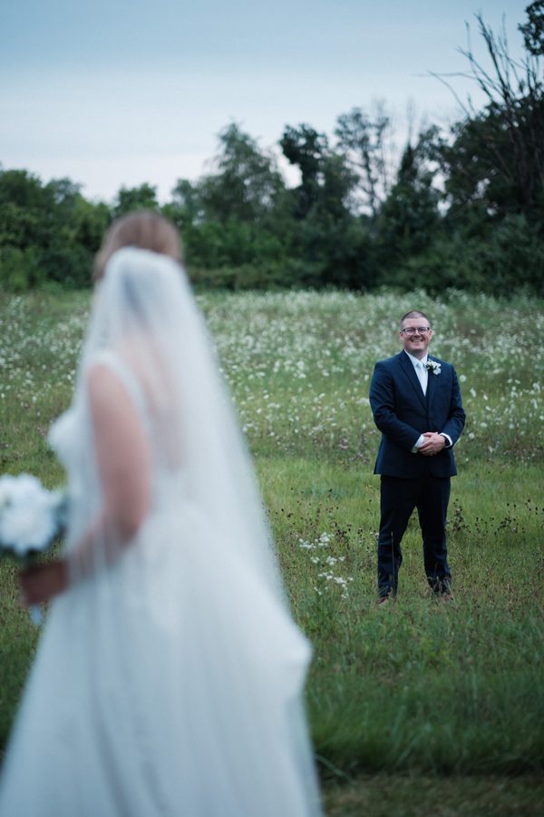 Eric smiling at Alyssa across the wildflowers