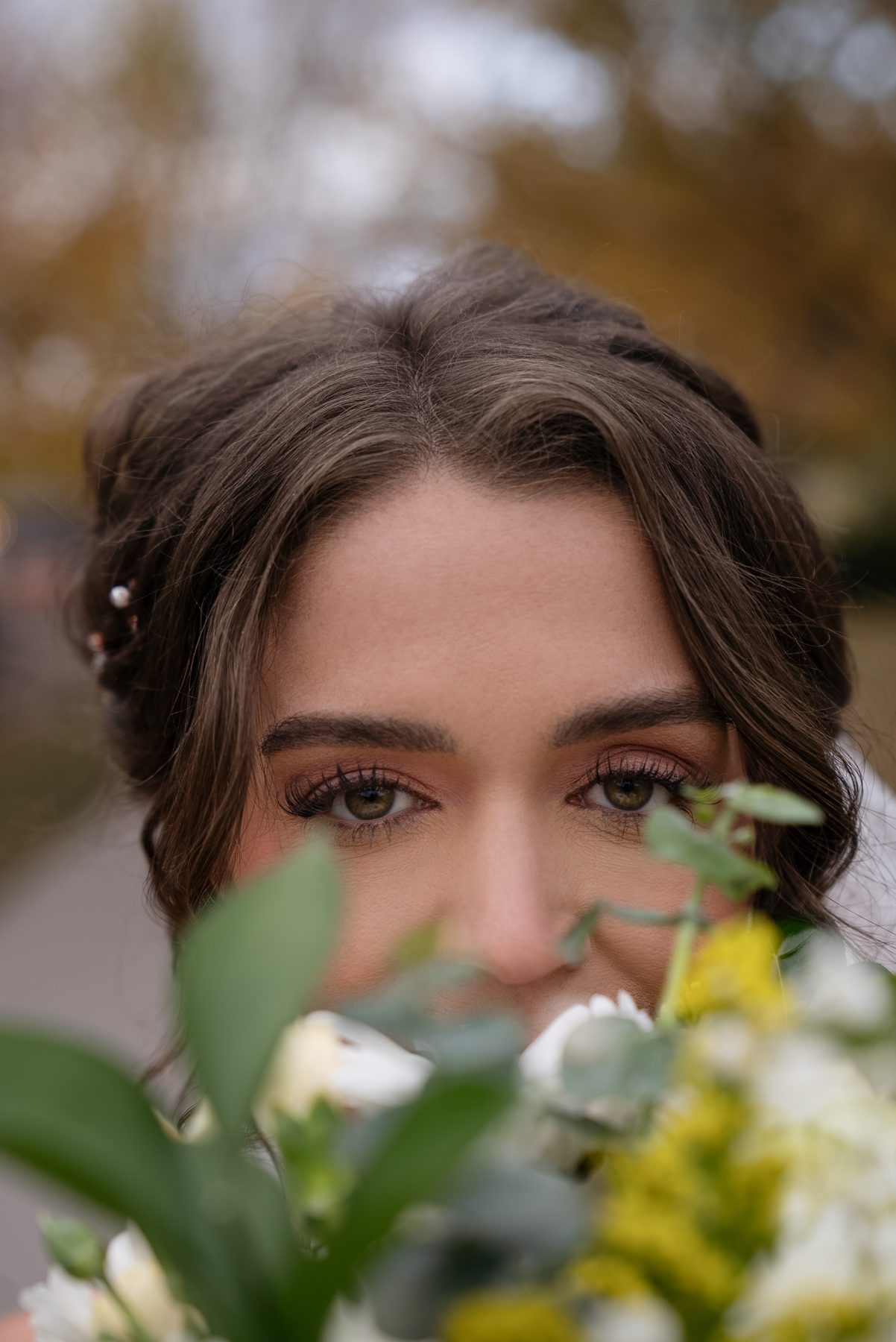 Pary peeking over her bouquet