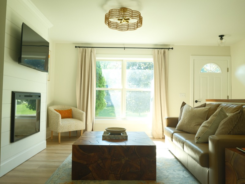 Living room with a wood block coffee table and gold ceiling light